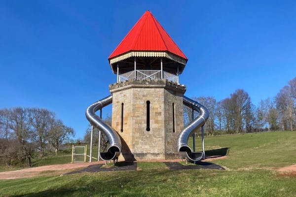 Wooden castle-topped play fortress with the four-lane Folly Slide running down the front